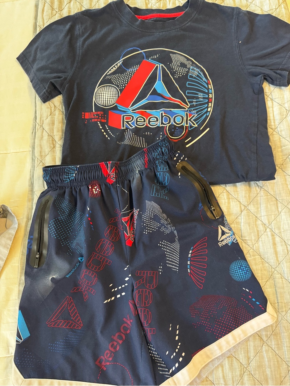 Reebok Navy Graphic Tee and Athletic Shorts with Red & Blue Accents.
